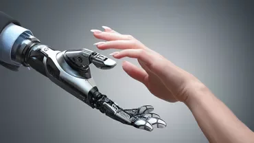 A human hand reaching towards a robotic hand.